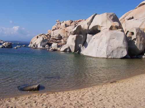 Plage de sable fin bordée de rochers imposants aux îles Lavezzi en Corse