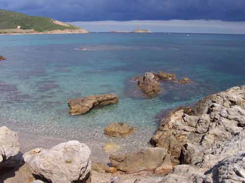 Eaux cristallines et rochers immergés dans une crique préservée du Cap Corse