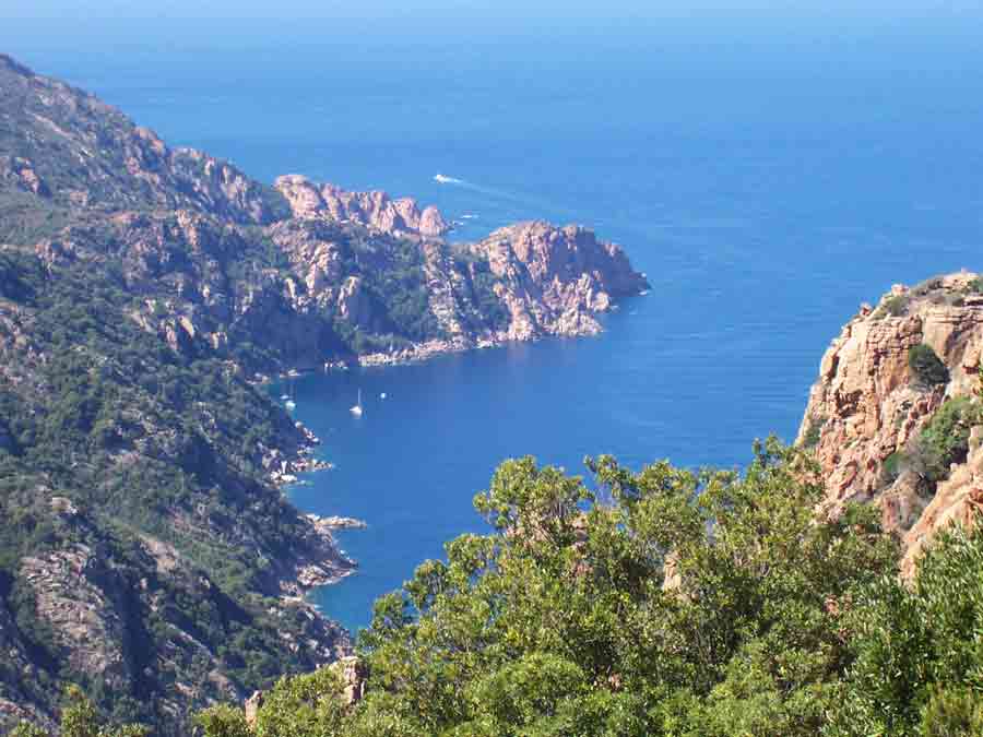 Vue plongeante sur les calanques de Piana en Corse, roches rouges découpées plongeant dans une mer turquoise